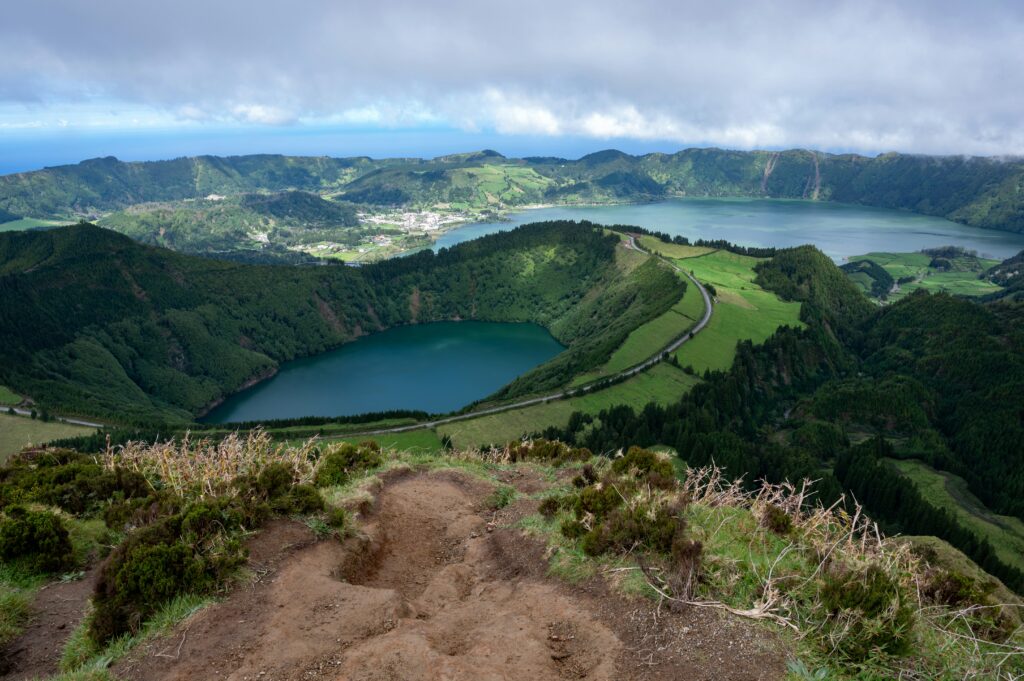 A serene crater lake surrounded by lush green cliffs