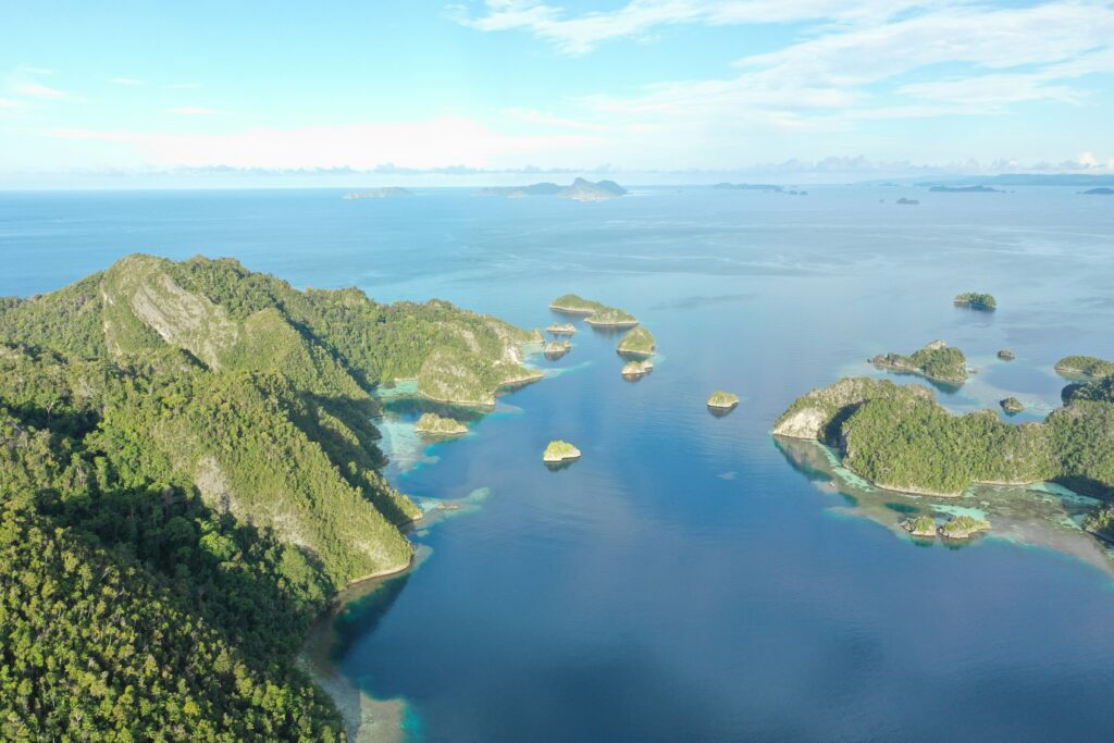 Turquoise waters of Raja Ampat dotted with lush green karst islands