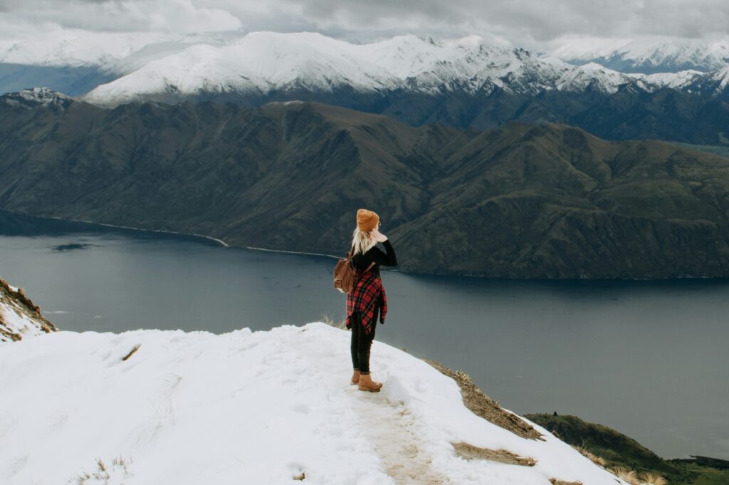 Woman standing on a glacier during a heli hike in New Zealand - luxury travel adventure