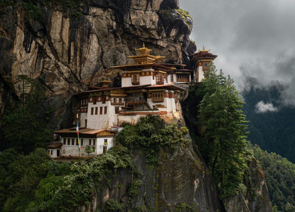 The iconic Tiger’s Nest Monastery perched dramatically on a cliffside, enveloped in morning mist.